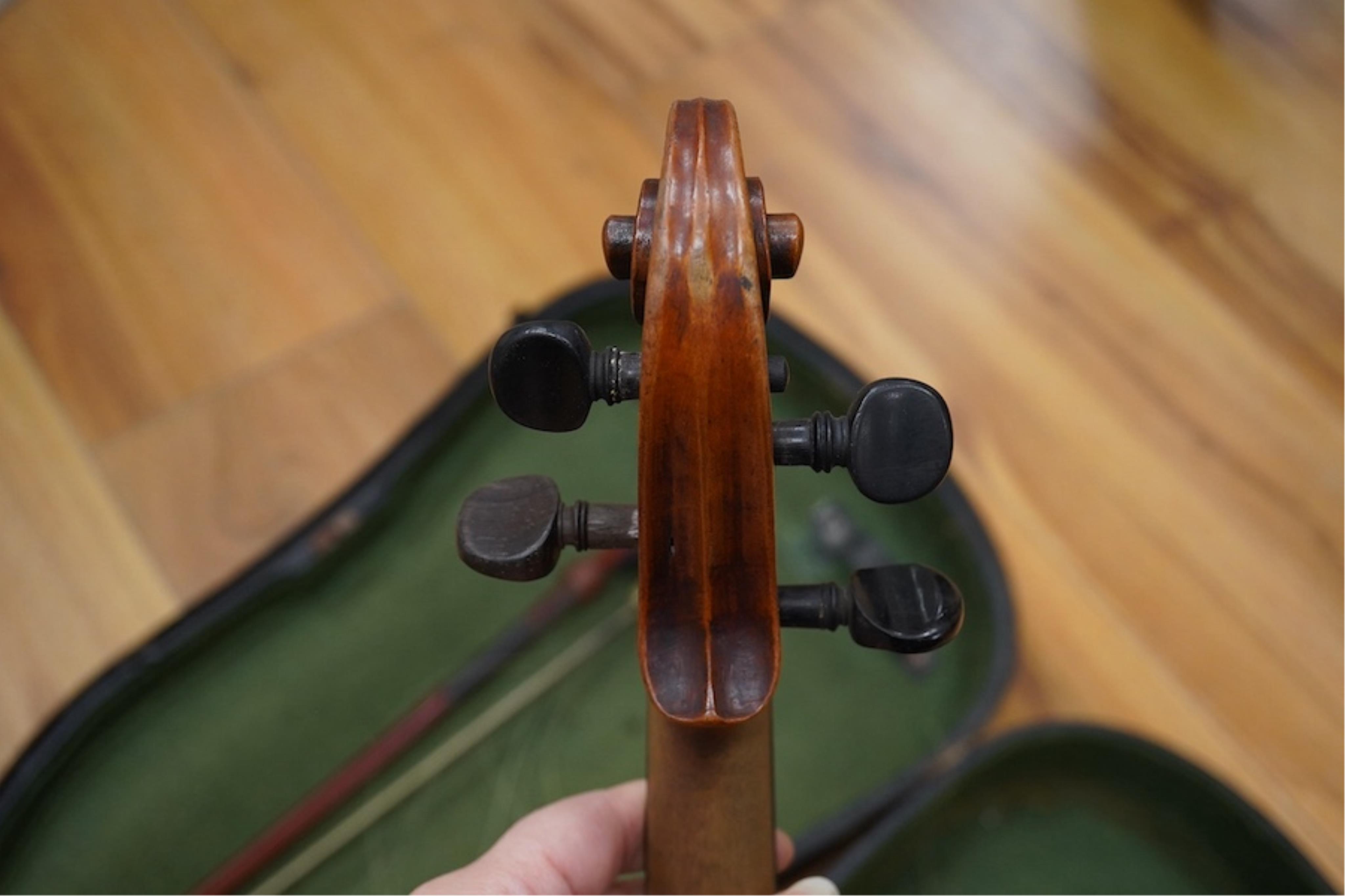 A late 19th cased century French unmarked violin and bow, body 35cm high.